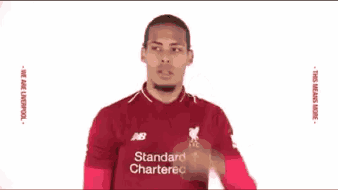 a man in a red shirt is holding his head .