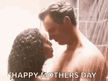 a man and a woman are kissing in the shower .
