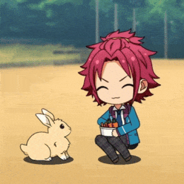a boy with red hair is sitting next to a small bunny