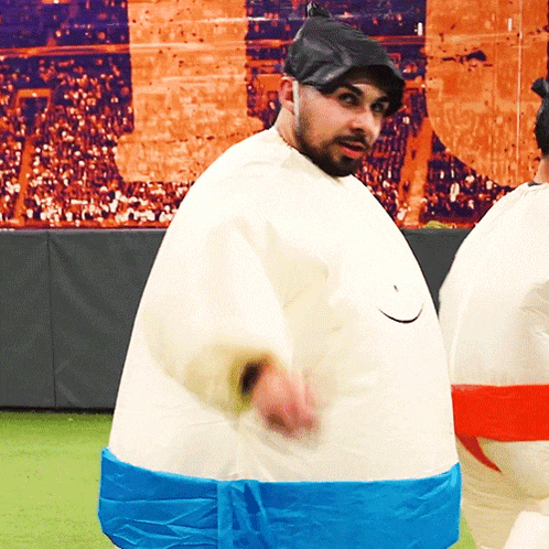 a man in an inflatable sumo costume is dancing