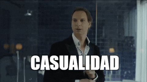 a man in a tuxedo stands in front of a glass wall with the word casualidad written above him