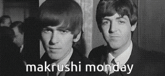 a black and white photo of two men standing next to each other with the words makrushi monday in the corner .