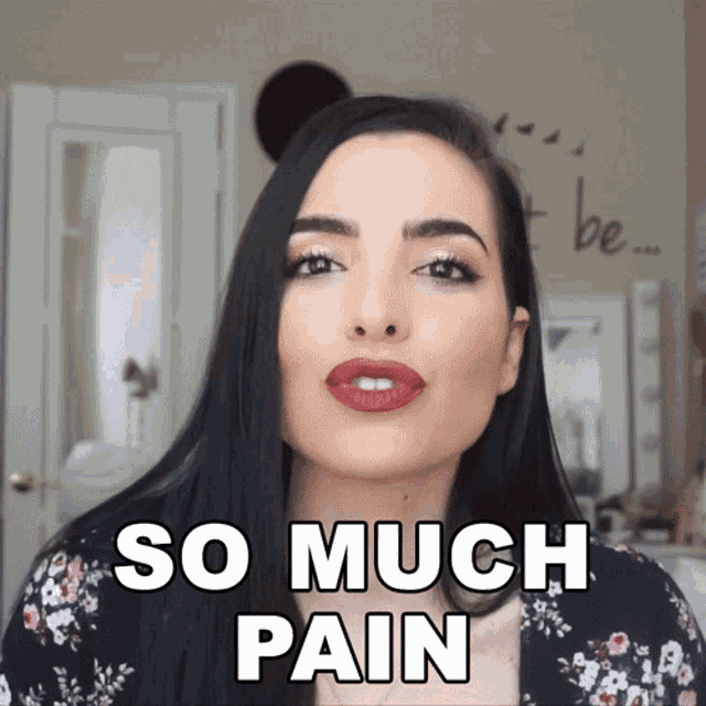 a woman says so much pain in a floral shirt