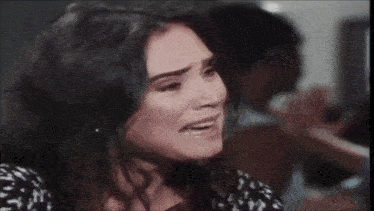 a close up of a woman 's face with a tear running down her face