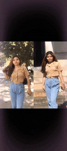 a woman in a crop top and blue jeans is standing in front of a building