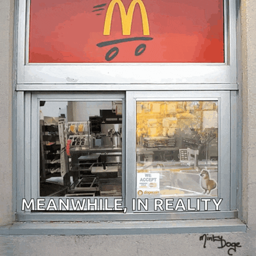 a window of a mcdonald 's with the words meanwhile in reality
