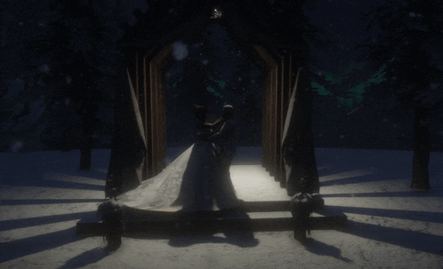 a bride and groom are dancing in a snowy forest