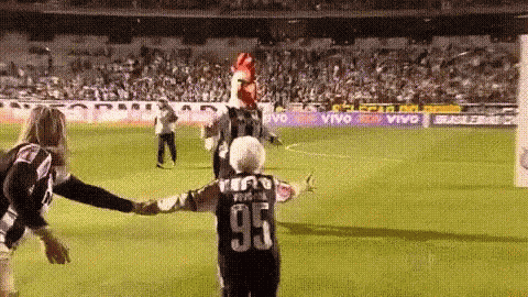 a person wearing a jersey with the number 95 on it stands on a soccer field