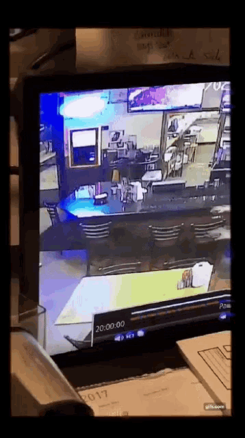 a computer monitor shows a diner with the time of 20:00 on the screen