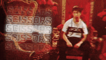 a man sitting in front of a sign that says scissors scissors scissors
