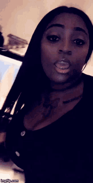 a woman with a tattoo on her chest is taking a picture with imgflip.com