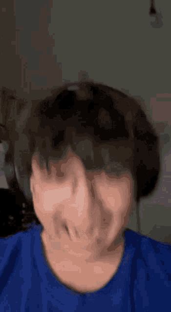 a close up of a person making a funny face while wearing headphones .