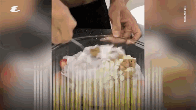 a video of a person preparing food with the letter e on the bottom right
