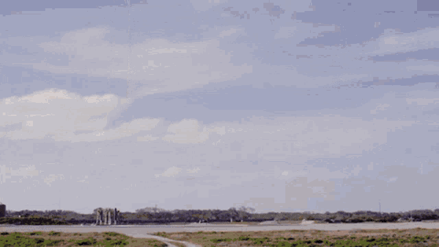 a rocket is being launched into the sky with a lot of dust coming out of it