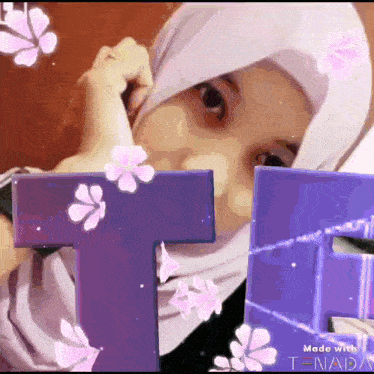 a girl wearing a hijab is surrounded by purple letters and pink flowers