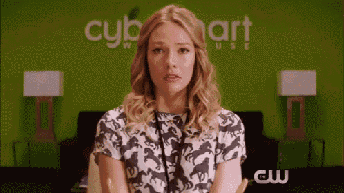 a woman is sitting in front of a green wall that says cybe smart