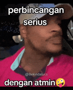 a man wearing a hat and a pink jacket with the words perbincangan serius dengan atmin below him