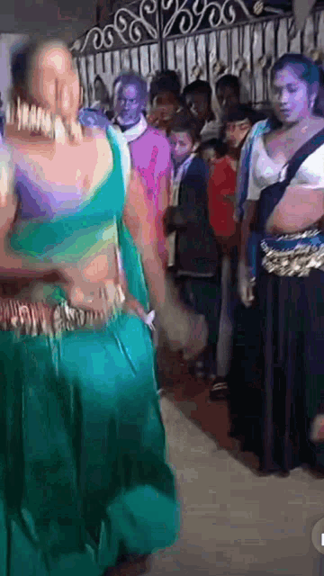 a woman is dancing in front of a crowd of people .