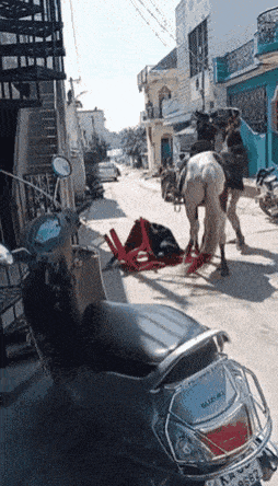 a suzuki scooter is parked on the street
