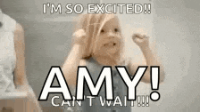 a little girl is standing in front of a sign that says amy