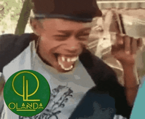 a man is making a funny face in front of a green circle with the word olanda on it