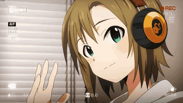 a girl wearing headphones is being recorded in a video