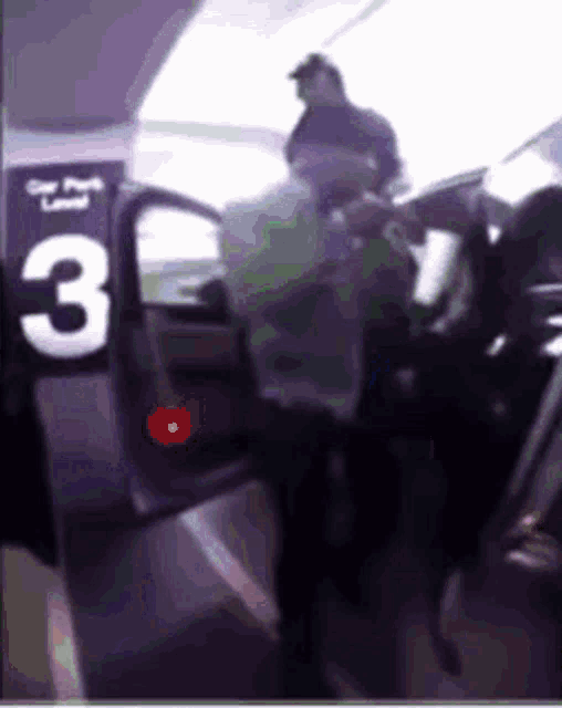 a man getting out of a car with the number 3 on it