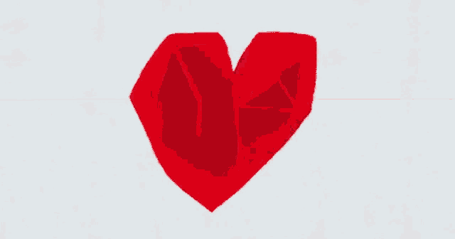 a red heart is floating in the air on a white background