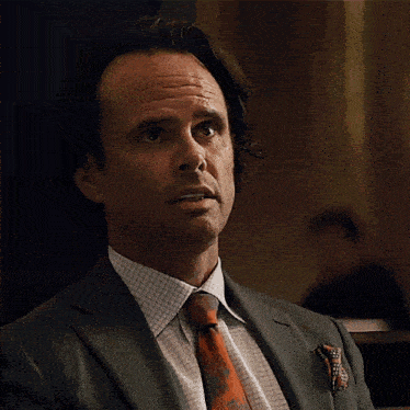 a man in a suit and tie is looking up