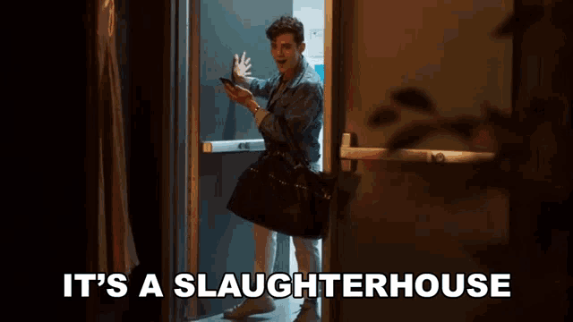 a man standing in a doorway with the words it 's a slaughterhouse