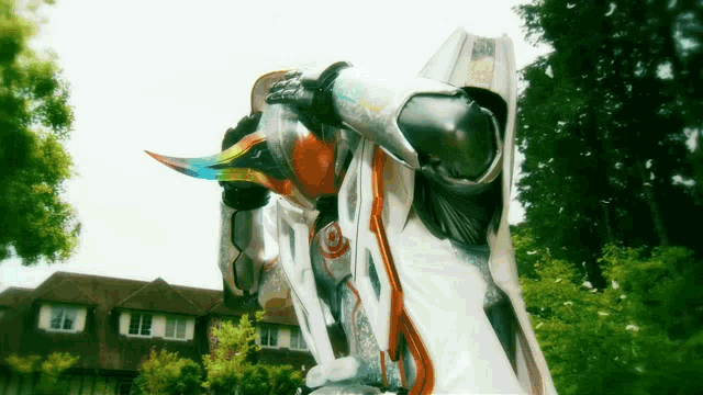 a person in a white and orange costume with a long horn
