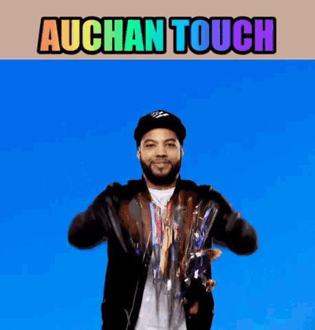a man wearing a hat and a jacket is dancing in front of a blue background with the words auchan touch above him