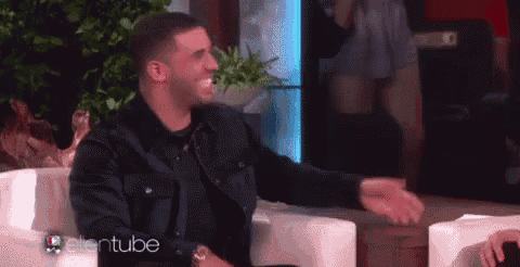 a man in a black jacket is sitting in a chair with his arms outstretched while talking to ellen .