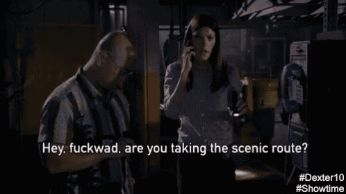 a man and a woman are talking in a dark room and the man says hey fuckwad are you taking the scenic route .