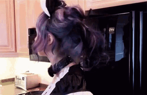 a woman with purple hair is wearing bunny ears and a collar