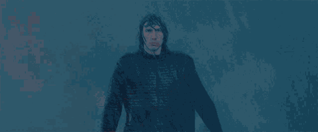 a man is holding a red light saber in his right hand