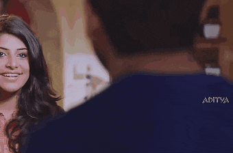 a man with a beard is wearing a blue shirt that says aditya on it
