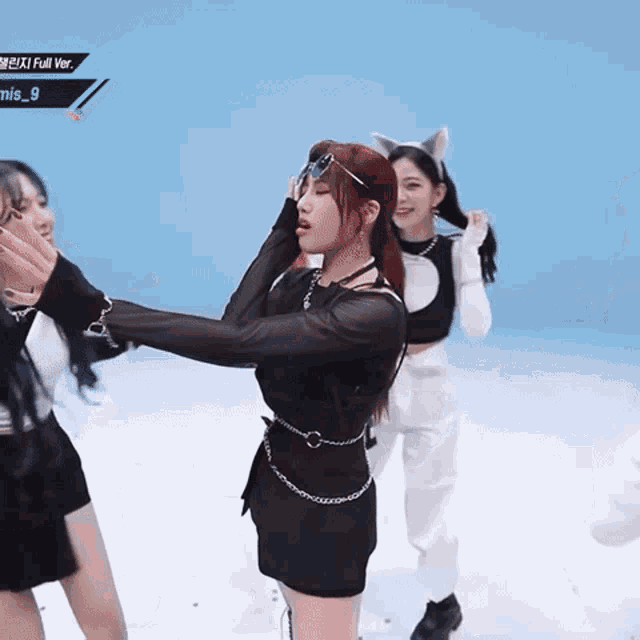 a girl with red hair is wearing sunglasses and a cat ear headband while dancing
