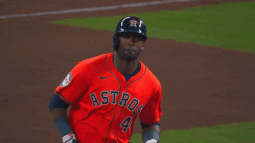 a baseball player for the astros wears a red jersey