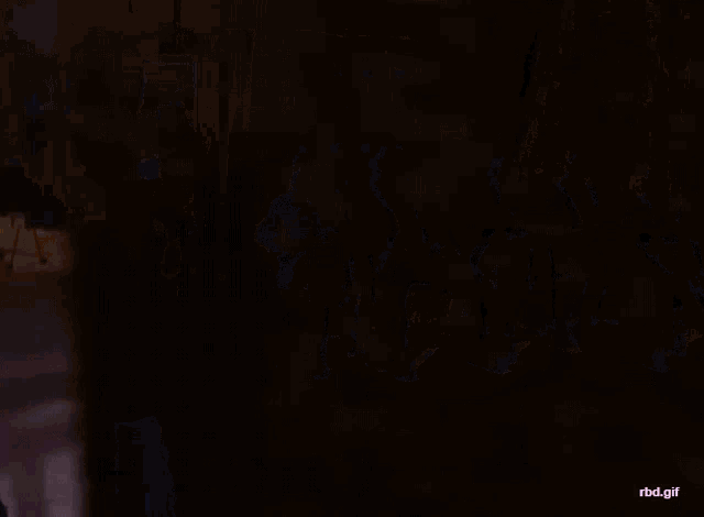 a group of people sit in chairs in a dark room