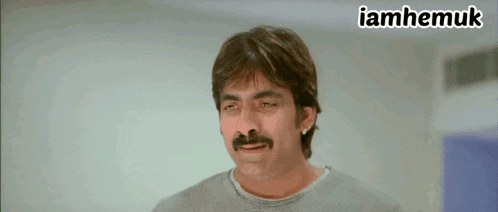 a man with a mustache and the word iamhemuk on the bottom right