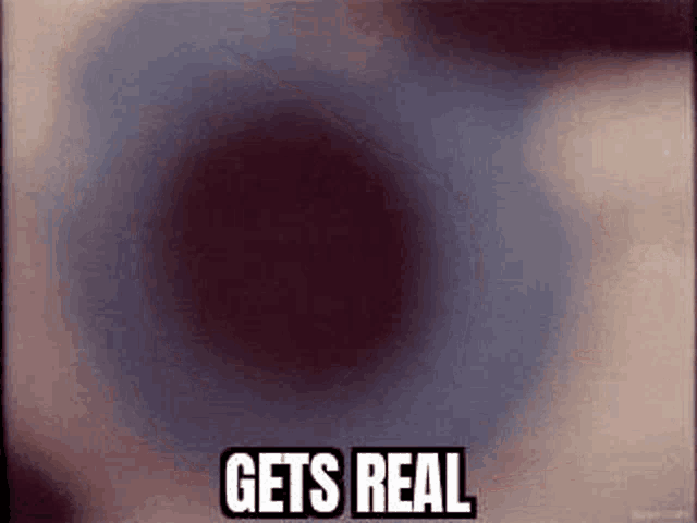 a close up of an eye with the words `` gets real '' written on it .