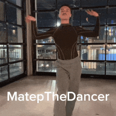 a man with a mustache is dancing in a room with the words matep the dancer above him