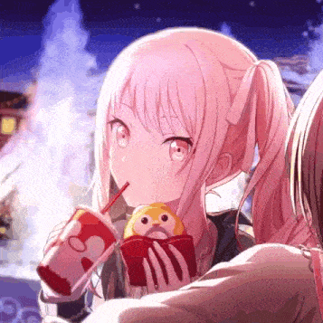 a girl is holding a stuffed animal and drinking from a cup .