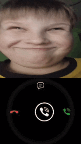 a young boy is smiling and talking on a cell phone