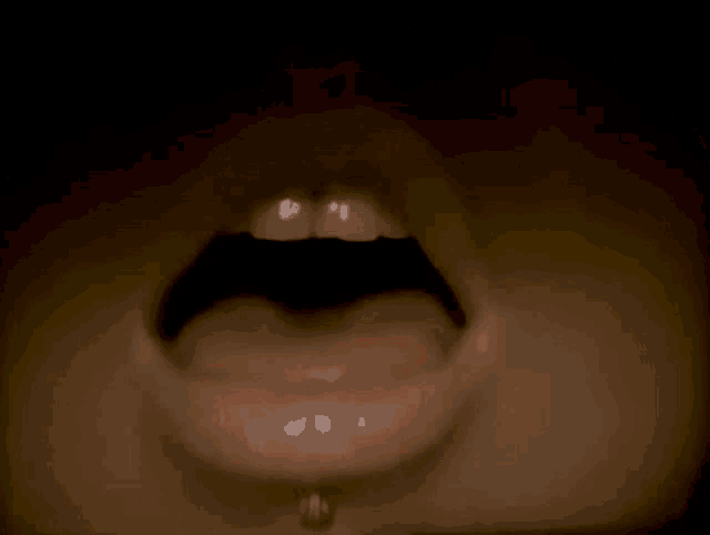 a close up of a person 's mouth with their tongue out