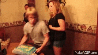 a man and a woman are sitting at a table with a cake in front of them ..