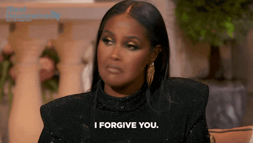 a woman is saying i forgive you while sitting on a couch