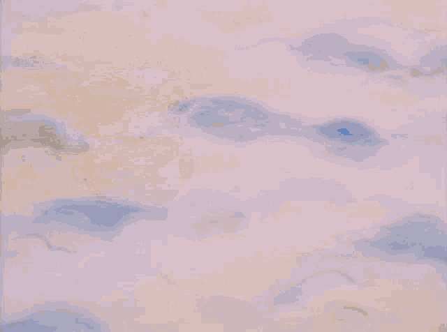 a blue care bear is flying through the air while wearing a hat with stars on it .