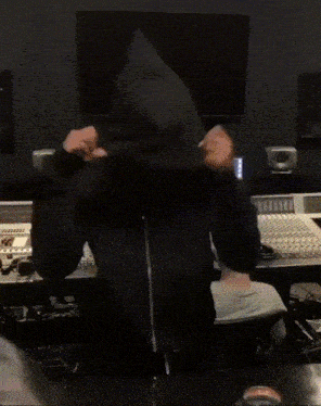 a person is dancing in front of a laptop